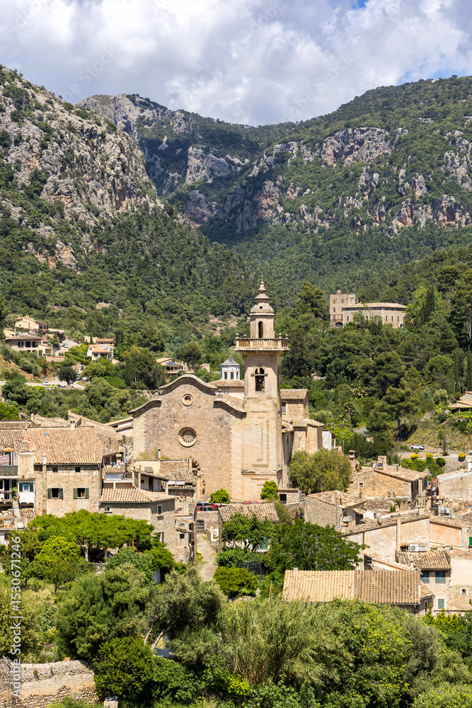 Obraz premium Valldemossa village on Mallorca island with church holiday at Serra de Tramuntana portrait format in Spain