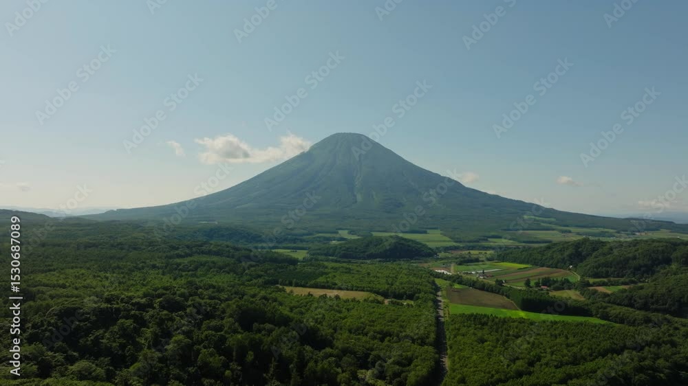 Aerial establishing view of Mount Yotei Amidst green fertile forested fields in Hokkaidō Japan Aerial establishing view of Mount Yotei Amidst green fertile forested fields in Hokkaidō Japan