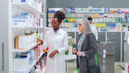 Tableau sur toile Woman pharmacist advising medicine to female client