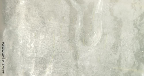 Close-up of the aloe vera leaf pulp. Drops of aloe juice trickle down the gel-like surface. Extract from leaves of aloe vera. Gel serum of aloe vera.