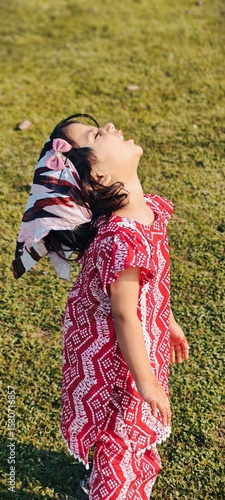 young woman in a field in Pakistan