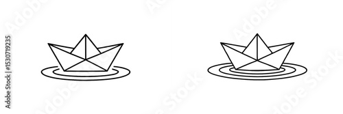 Origami paper boats floating on calm water with gentle ripples during a peaceful afternoon