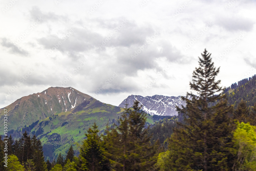 Fototapeta premium Tyrol Austria alpine mountain and hill landscape panorama cloudy sky.