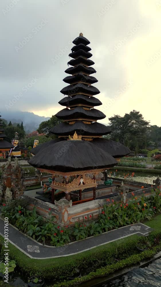 Aerial view of the iconic Ulun Danu Beratan Temple on the lake in Bali, Indonesia. Serene water and peaceful tropical surroundings. Aerial view of the iconic Ulun Danu Beratan Temple on the lake in Bali, Indonesia. Serene water and peaceful tropical surroundings.