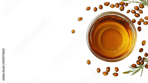 Golden oil in a glass container with seeds and green leaves nearby, showcasing natural ingredients and culinary use