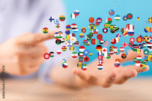 Image of hands holding many flags, symbolizing global unity and international connections.