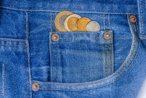 Money in Colombian pesos inside a pair of jeans pocket, a concept of personal savings.