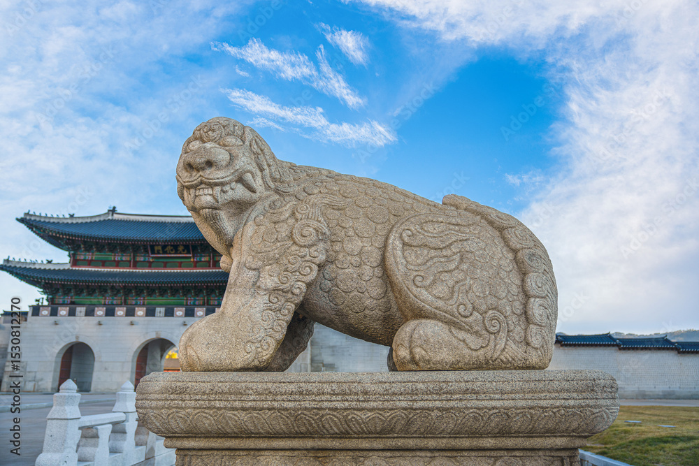 Gyeongbokgung Palace has a beautiful lion statue in front of the gate and the sign says Gwanghwamun Gate, Seoul, South Korea. November 11, 2024 Gyeongbokgung Palace has a beautiful lion statue in front of the gate and the sign says Gwanghwamun Gate, Seoul, South Korea. November 11, 2024