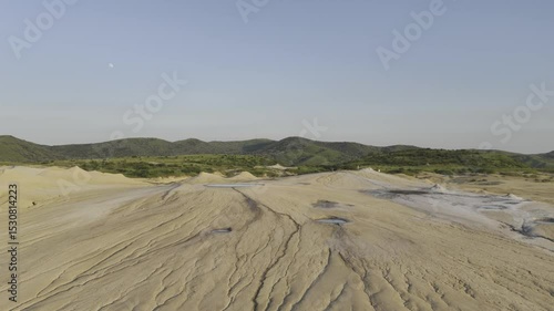 Buzău's Boiling Mud Volcanoes.
This aerial video captures a surreal landscape in Buzău County, Romania, showcasing the unique and otherworldly Muddy Volcanoes. 
