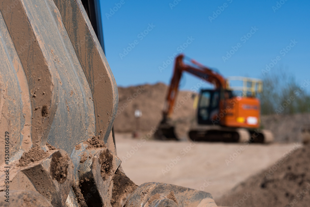 Fototapeta premium A depth of field blurred shot of a exavator vehicle in the background