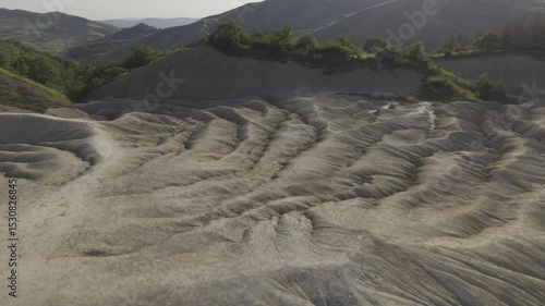 Buzău's Boiling Mud Volcanoes.
This aerial video captures a surreal landscape in Buzău County, Romania, showcasing the unique and otherworldly Muddy Volcanoes. 