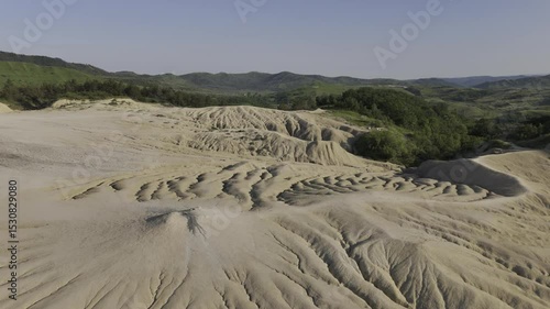 Buzău's Boiling Mud Volcanoes.
This aerial video captures a surreal landscape in Buzău County, Romania, showcasing the unique and otherworldly Muddy Volcanoes. 