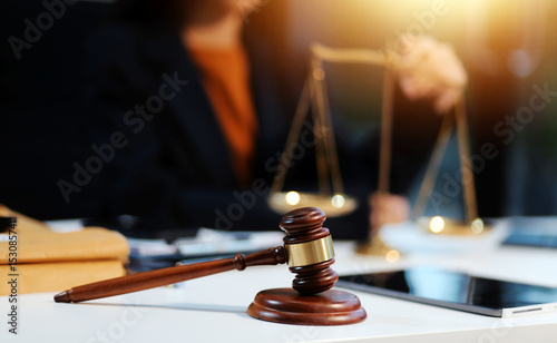 Judge gavel with Justice lawyers having team meeting at law firm background. Concepts of Law and Legal services.