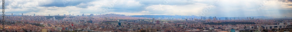 Wide panoramic view of Ankara city skyline with urban buildings, hills, and cloudy sky. Capital of Turkey showing modern and traditional elements blending in vibrant cityscape.
Wide panoramic view of Ankara city skyline with urban buildings, hills, and cloudy sky. Capital of Turkey showing modern and traditional elements blending in vibrant cityscape.
