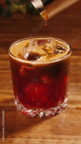 Making espresso tonic in transparent glass