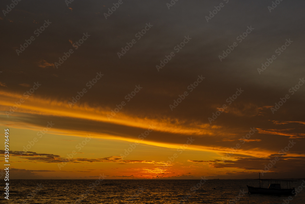 Beautiful dramatic orange sunset on a beach. Beautiful dramatic orange sunset on a beach.