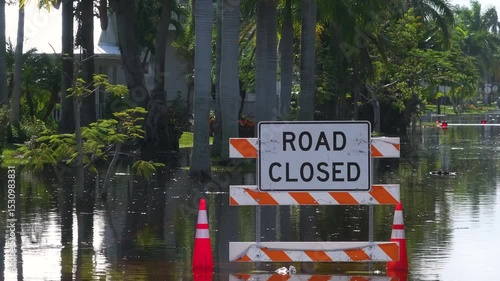Hurricane Milton aftermath in Punta Gorda, Florida. City street closed because of flooding with warning signs blocking driving of cars.