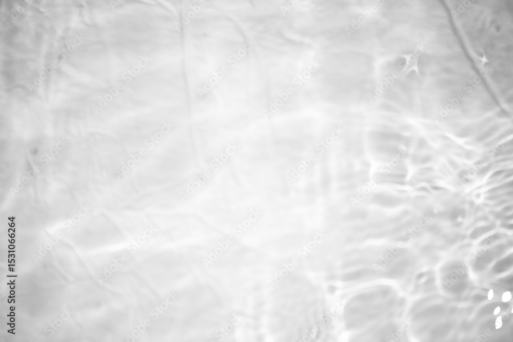 Obraz premium White water with ripples on the surface. Defocus blurred transparent white colored clear calm water surface texture with splashes and bubbles. Water waves with shining pattern texture background.