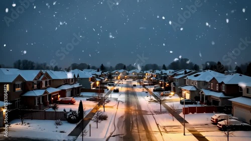 Snowfall over Suburban Neighborhood at Dusk: Winter Scene with Illuminated Streets and Houses
