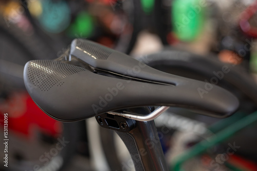 Detail of the sport saddle for bicycle. Elegant black and white racing saddle on the seat post, close-up.Racing bike.