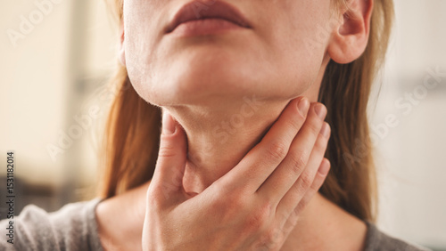 Young woman pulping her inflamed neck
