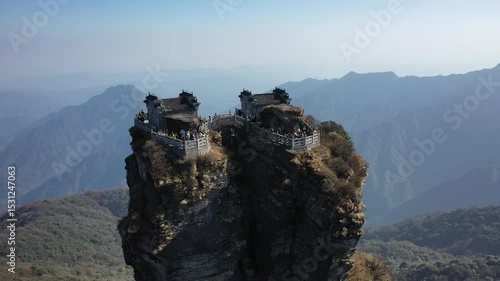 Aerial view of Fanjing Mountain temple at Tongren Guizhou on a hazy day, with people visible enjoying the scenic mountaintop views