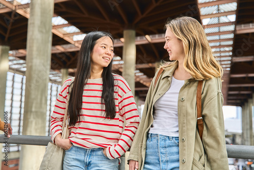 Wallpaper Mural Two young women talking and smiling at the station Torontodigital.ca