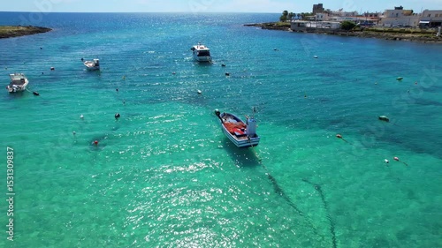 Torre Colimena - Italy, Apulia - rising boomerang aerial view of the bay with boats