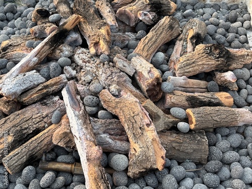 Fire wood logs and firepit stones up close textured background photography