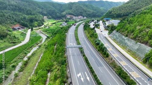 Aerial View of Lush Green Mountains and River Road in Fujian Province
