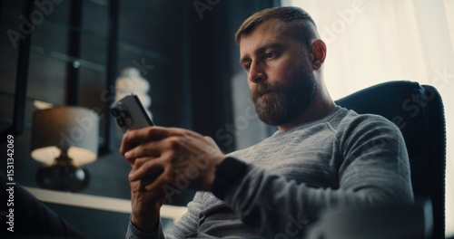 Professional Stock Exchange Trader Monitoring Real-Time Stocks and Exchange Market Charts Using Smartphone, Drinking Coffee. Successful Investment Agent Working in Cozy Office of Financial Agency.