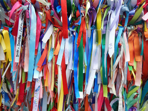 Colorful ribbons adorning a railing on a bridge