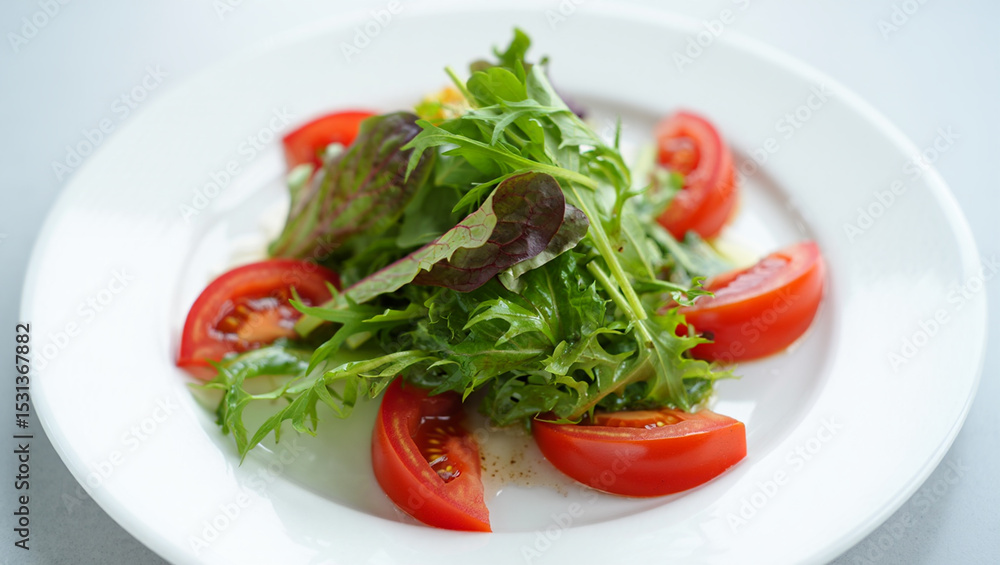 Fresh Red Tomato and Mixed Green Salad on White Plate Simple Food Photography Vibrant Colors Healthy Eating Concept Fresh Red Tomato and Mixed Green Salad on White Plate Simple Food Photography Vibrant Colors Healthy Eating Concept