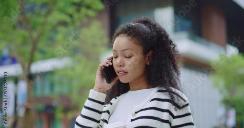 Businesswoman with coffee enjoying phone call
