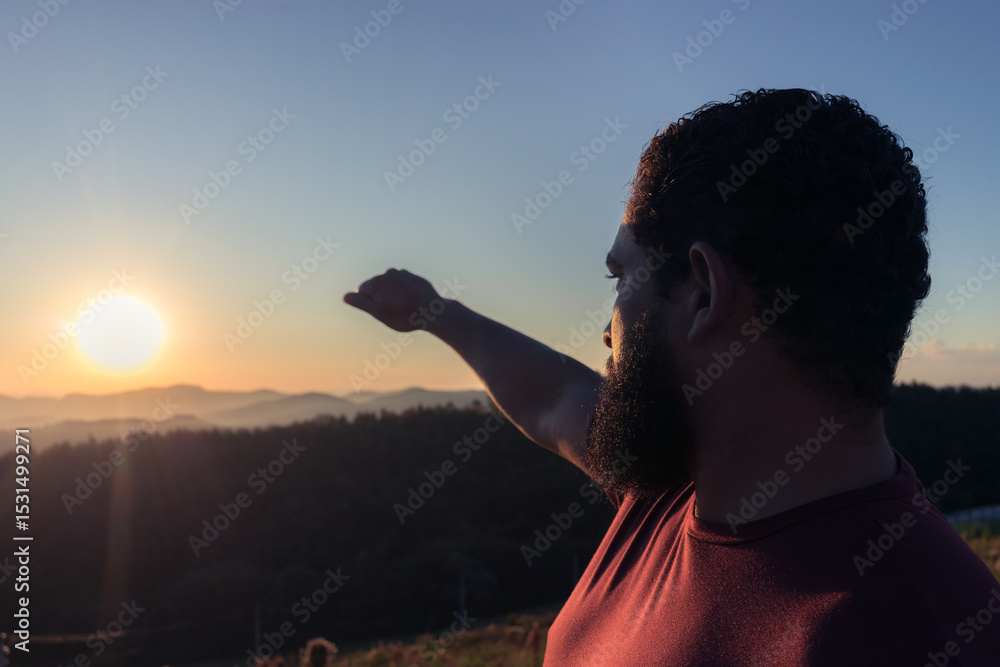 Fototapeta premium man at sunset in the mountains looking deeply thoughtfully at the horizon
