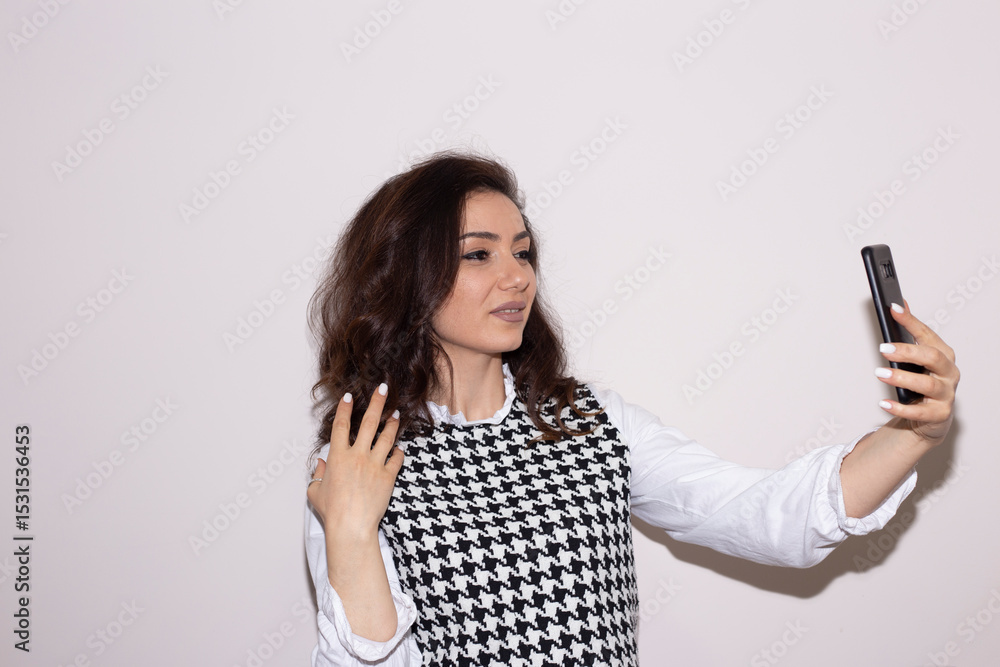Fototapeta premium woman holding mobile phone taking selfie photo using smartphone camera