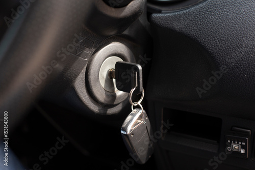Car key in an auto ignition waiting for a driver.