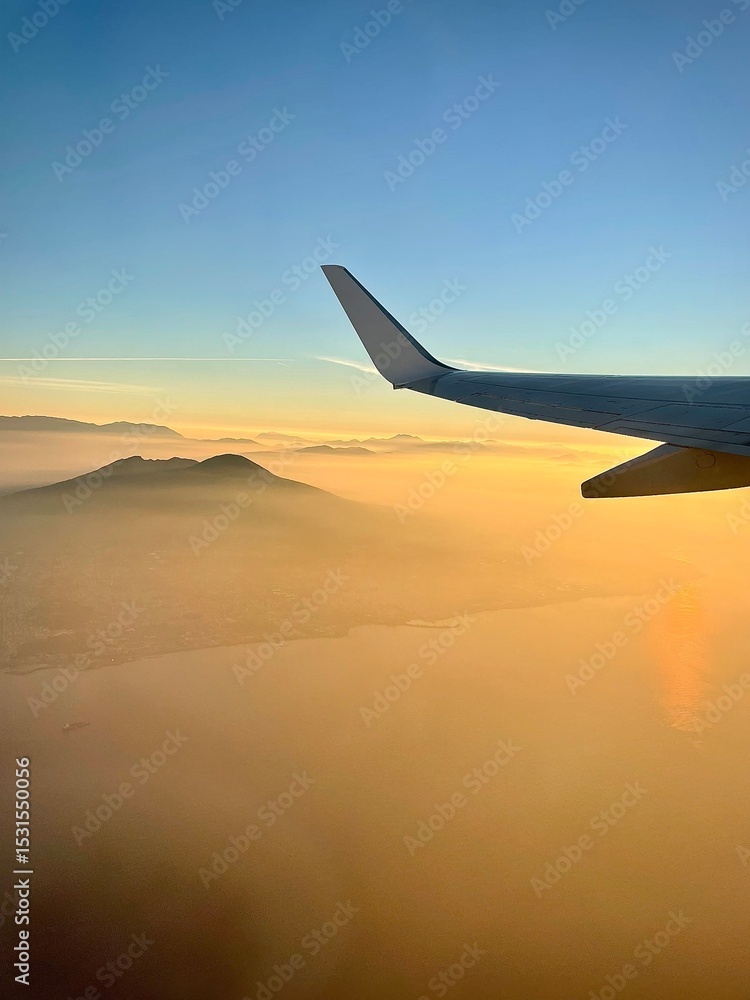 Obraz premium Airplane wing view at sunrise during flight
