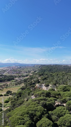 Close drone flyby along forested coastal cliffs in Portugal. Rich textures of rock and dense greenery blend with ocean backdrop. Immersive, dynamic flight with intense natural presence and detail.

