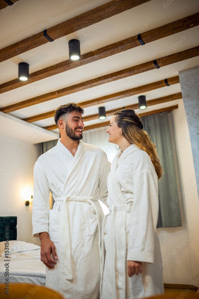 Fototapeta premium Couple in Bathrobes Looking at Each Other in Hotel Room