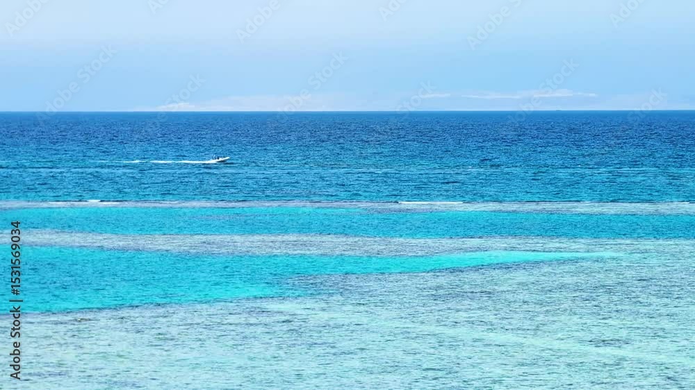 Beautiful summer view of bright turquoise ocean with coral reef, red sea and fast going boat through the whole frame, happy vacation in warm countries, water movement and shine of waves in sunlight Beautiful summer view of bright turquoise ocean with coral reef, red sea and fast going boat through the whole frame, happy vacation in warm countries, water movement and shine of waves in sunlight