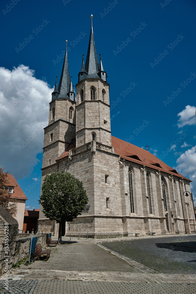Fototapeta premium Stunning Gothic Church Spire Majestically Rising Under a Beautiful, Clear Blue Sky. Germany.