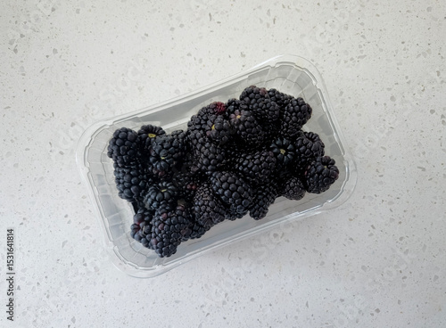 Fresh blackberries in a pint container