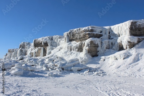 Wallpaper Mural Frozen cliffs and icy waterfalls.  A winter landscape with towering, ice-covered rock formations.  A lone figure on a high point Torontodigital.ca