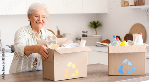 Senior woman with boxes of ...