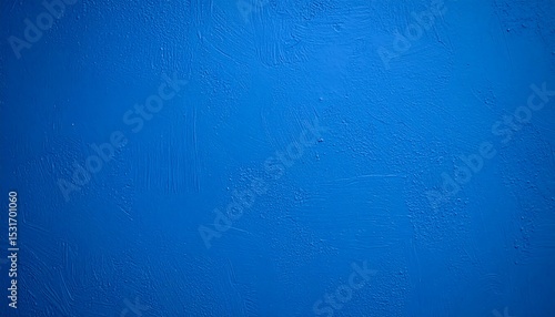 An abstract view of textured blue paint on a wall with visible brush strokes and uneven surface.