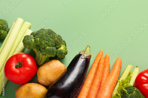 Different fresh vegetables on green background