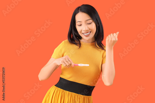 Happy young Asian woman wit...