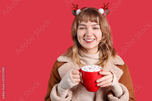 Pretty young woman holding ...