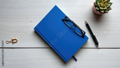 Royal blue hardcover journal on a weathered gray wood desk